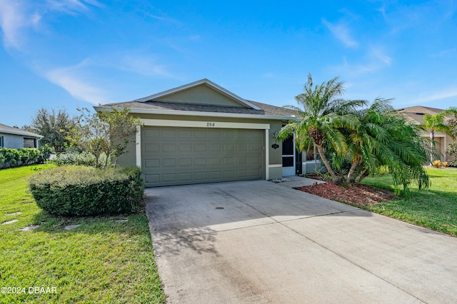 view of front of house featuring a garage and a front lawn