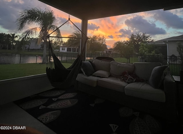 patio terrace at dusk with an outdoor living space and a yard