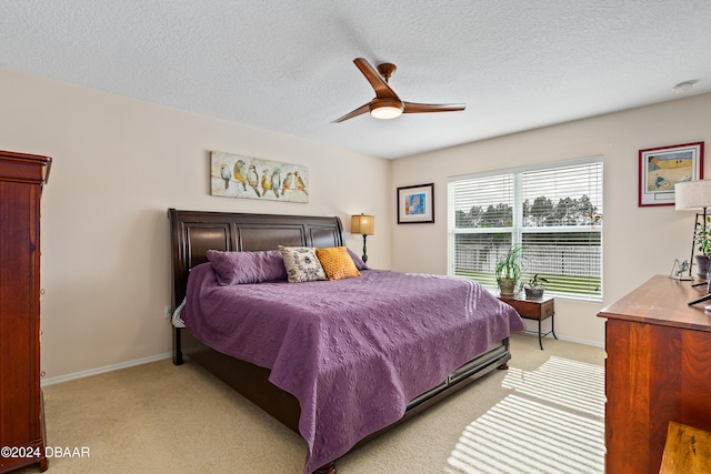 carpeted bedroom with a textured ceiling and ceiling fan