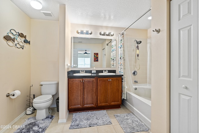 full bathroom with shower / bath combination with curtain, tile patterned floors, vanity, a textured ceiling, and toilet