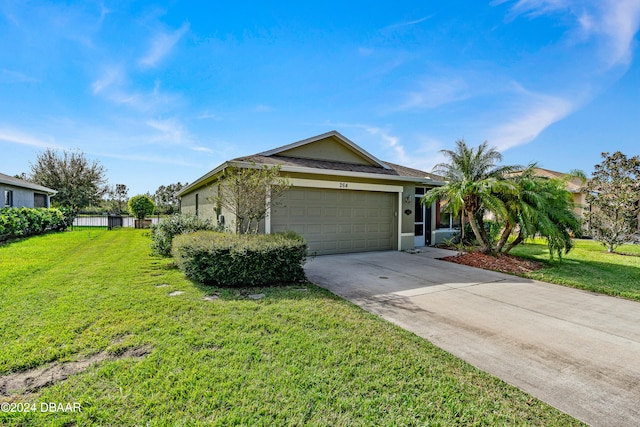 ranch-style house featuring a garage and a front lawn