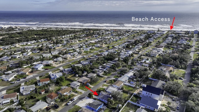 bird's eye view featuring a water view and a beach view