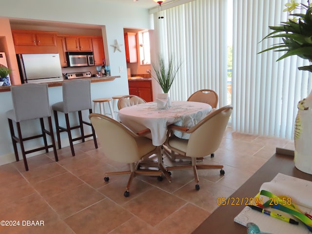 tiled dining room with a wealth of natural light