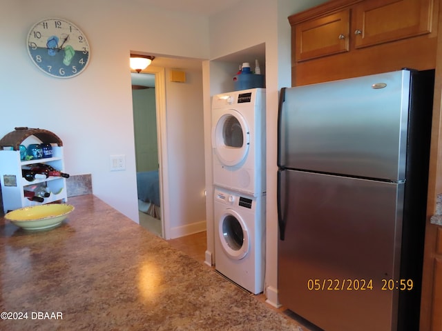 5500 Ocean Shore Blvd Unit 76, Ormond Beach, FL 32176 - laundry room with estacked washer and dryer and baseboards
