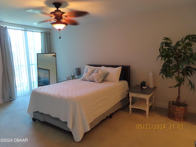 bedroom with carpet flooring, ceiling fan, and access to exterior