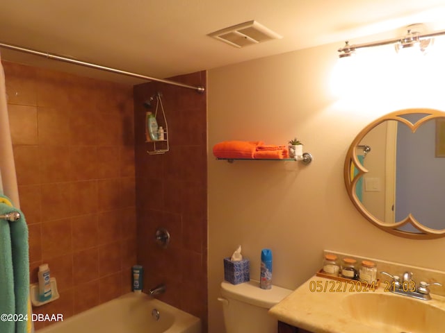 full bathroom featuring toilet, vanity, and tiled shower / bath