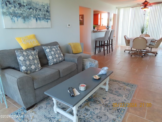 tiled living room featuring ceiling fan and a healthy amount of sunlight