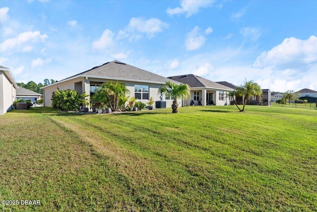 single story home with cooling unit and a front lawn