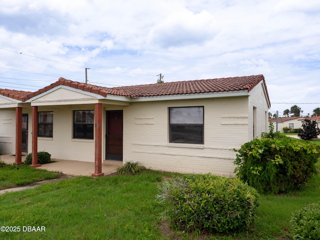 3 Oriole Cir Unit B, Ormond Beach, FL 32176 - ranch-style home featuring a patio, a tiled roof, and a front yard