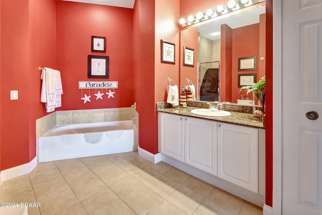 bathroom featuring a washtub, vanity, and tile patterned flooring