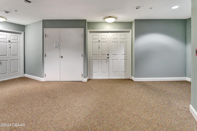 2 Oceans W Blvd Unit 204, Daytona Beach Shores, FL 32118 - unfurnished bedroom with baseboards, carpet floors, and multiple closets