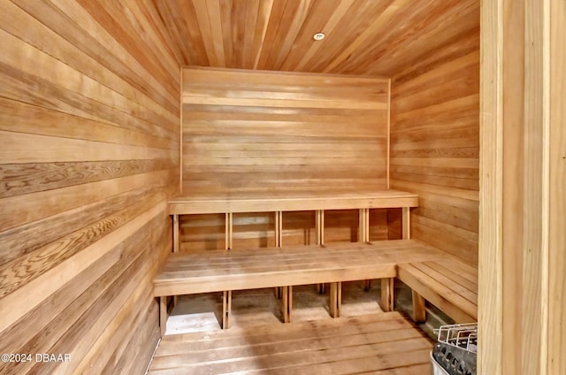 view of sauna / steam room with hardwood / wood-style floors, wood walls, and wooden ceiling