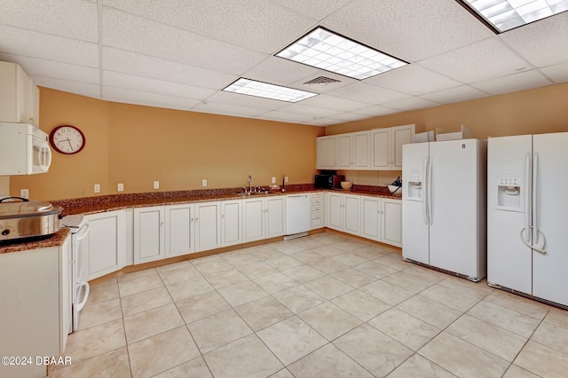 2 Oceans W Blvd Unit 204, Daytona Beach Shores, FL 32118 - kitchen with white appliances, a paneled ceiling, a sink, dark stone counters, and white cabinetry
