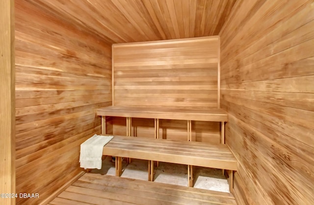 view of sauna / steam room featuring wooden walls and wood ceiling