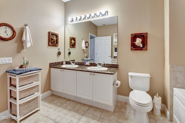 2 Oceans W Blvd Unit 204, Daytona Beach Shores, FL 32118 - full bath featuring double vanity, tile patterned floors, toilet, and baseboards