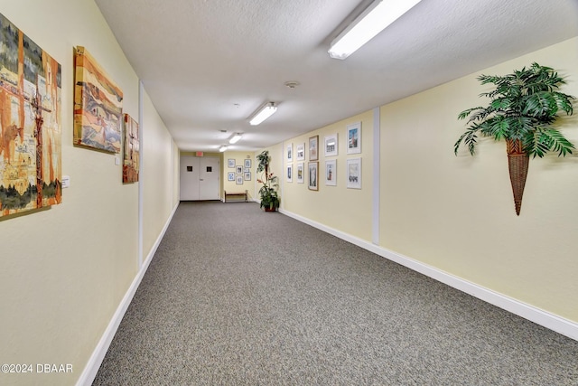 2 Oceans W Blvd Unit 204, Daytona Beach Shores, FL 32118 - corridor featuring dark carpet and baseboards