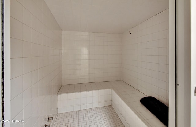 bathroom with tiled shower and tile patterned floors