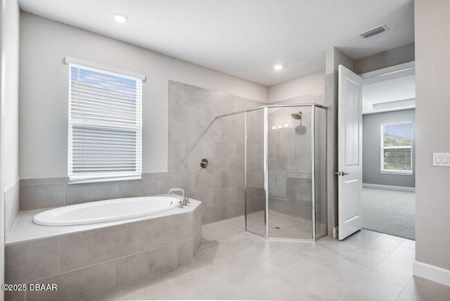 bathroom featuring tile patterned flooring and independent shower and bath