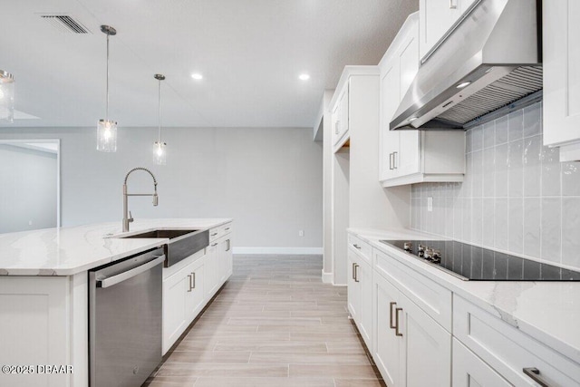 kitchen with black electric cooktop, white cabinets, stainless steel dishwasher, and ventilation hood