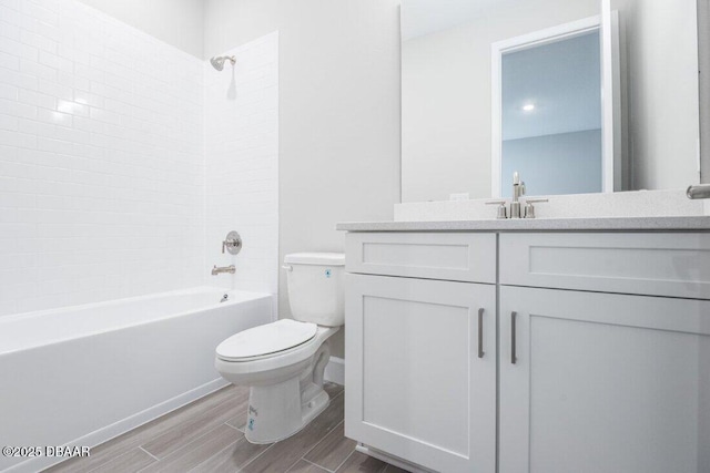 full bathroom with toilet, vanity, and tiled shower / bath combo