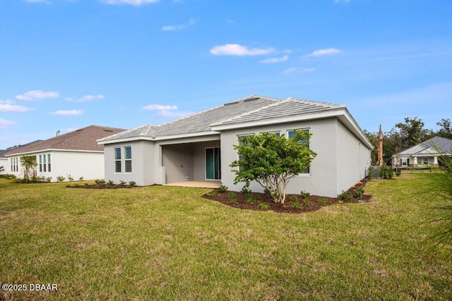 rear view of house with a yard