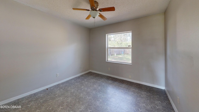 spare room with a textured ceiling and ceiling fan