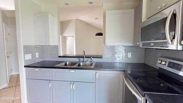 kitchen featuring tasteful backsplash, white cabinetry, sink, and stainless steel appliances