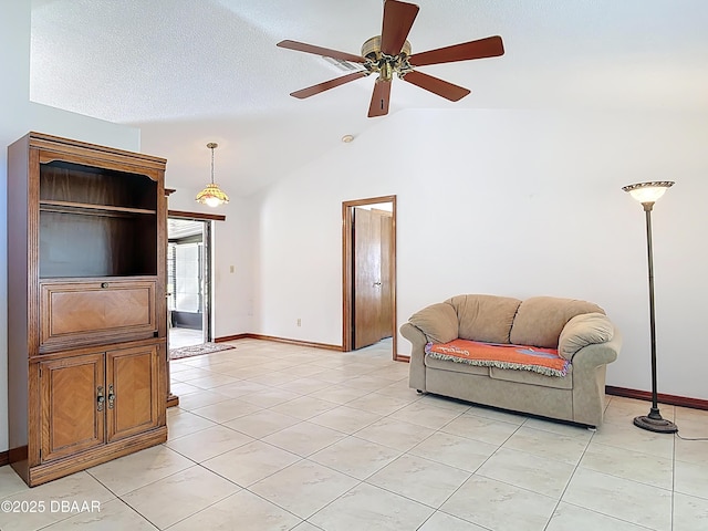 living room featuring lofted ceiling, light tile patterned floors, baseboards, and ceiling fan