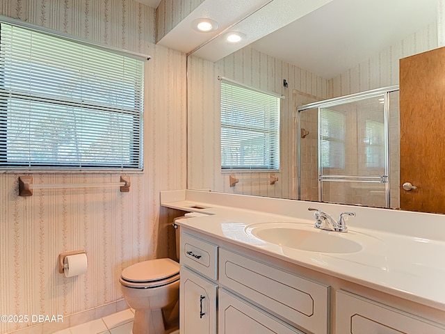 bathroom featuring toilet, a healthy amount of sunlight, a shower stall, and wallpapered walls