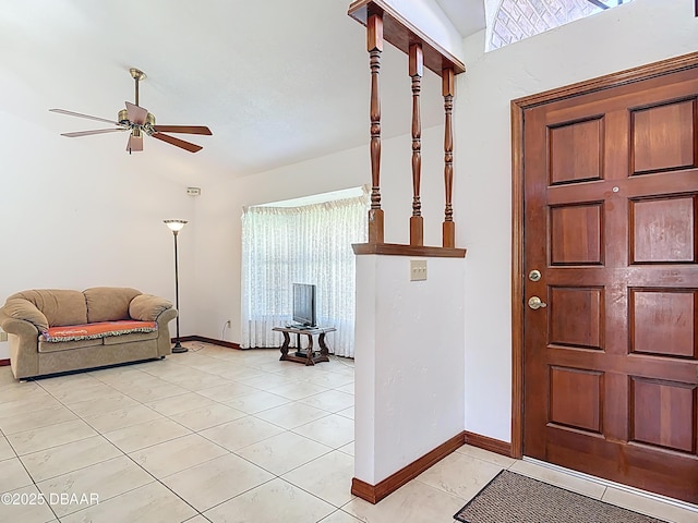 foyer with light tile patterned floors, ceiling fan, and baseboards