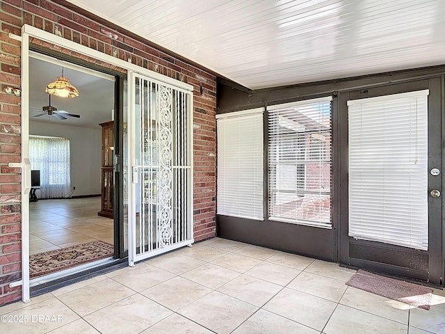 unfurnished sunroom with a ceiling fan