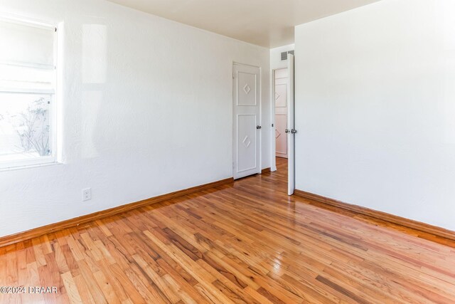 empty room with hardwood / wood-style floors