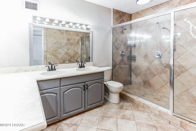 bathroom with walk in shower, tile patterned flooring, vanity, and toilet