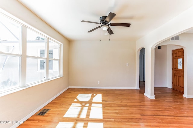 spare room with light hardwood / wood-style flooring and ceiling fan