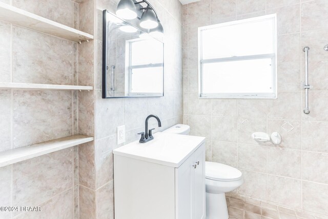 bathroom featuring tile walls, plenty of natural light, and vanity