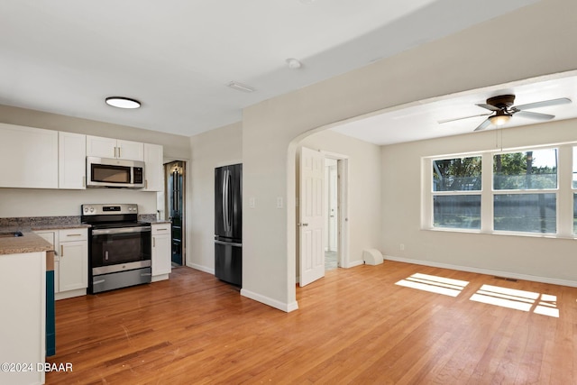 kitchen featuring white cabinetry, appliances with stainless steel finishes, ceiling fan, and light hardwood / wood-style floors