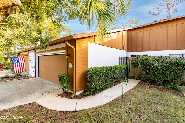 view of home's exterior with a garage and an outdoor structure