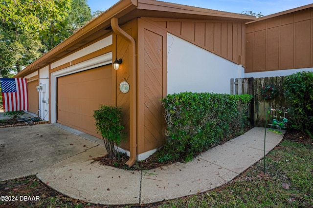 view of side of home with an outdoor structure and a garage