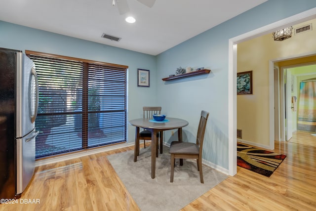 dining area with ceiling fan and light hardwood / wood-style floors