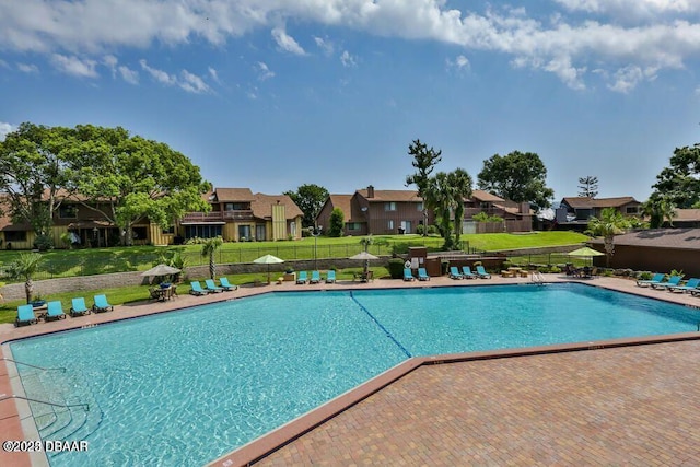 view of pool featuring a yard