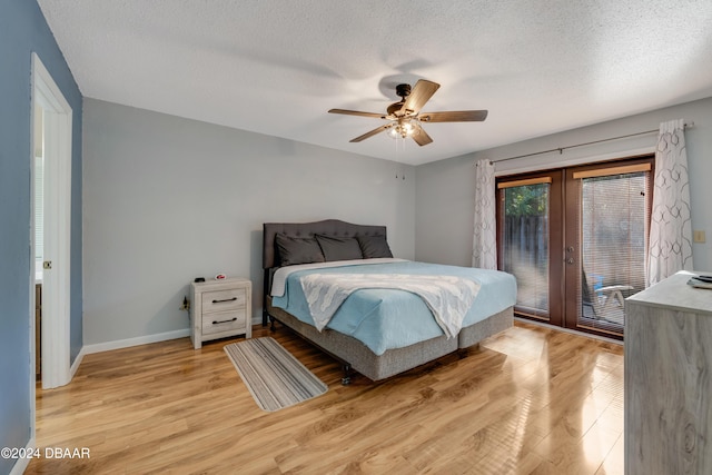 bedroom featuring french doors, access to outside, light hardwood / wood-style flooring, and ceiling fan