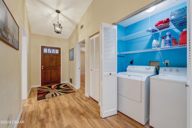 washroom featuring light hardwood / wood-style floors and washer and clothes dryer