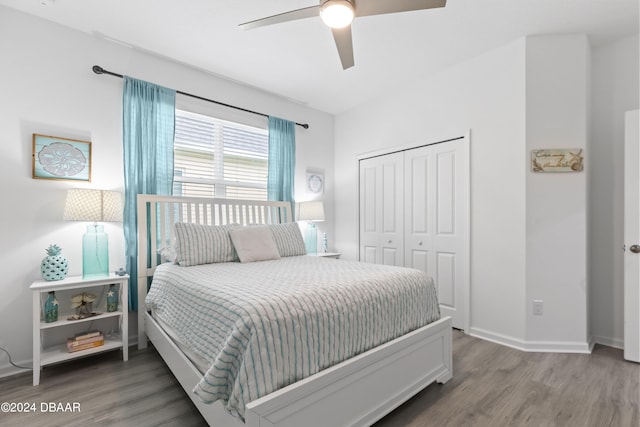 bedroom with hardwood / wood-style flooring, ceiling fan, and a closet