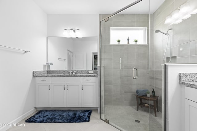 bathroom featuring vanity, tile patterned flooring, and a shower with shower door