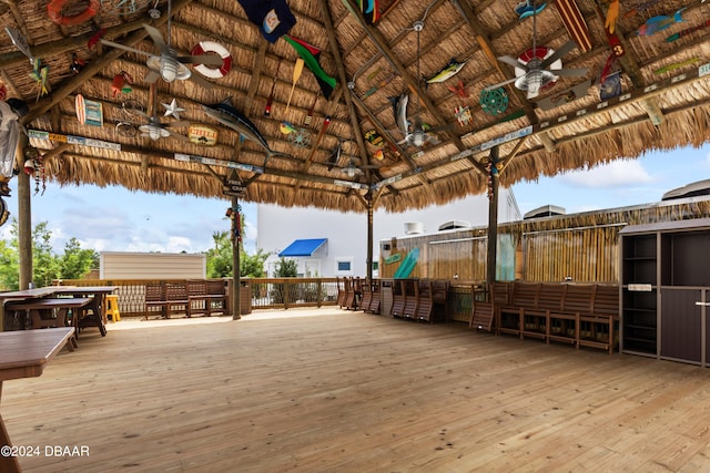 wooden terrace featuring ceiling fan and a gazebo