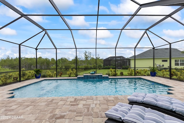 view of swimming pool featuring glass enclosure and a patio