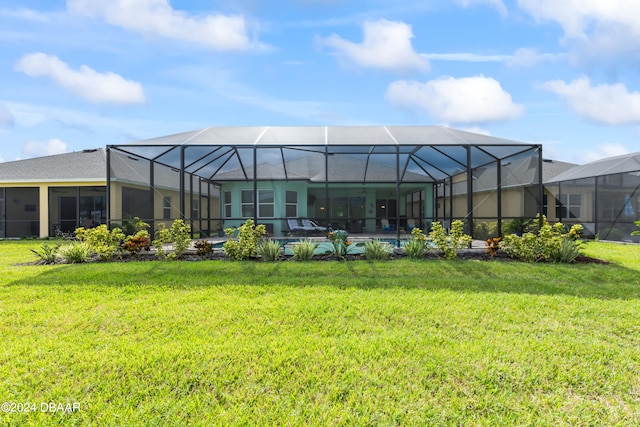 rear view of house with glass enclosure, a swimming pool, and a yard