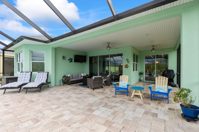 view of patio with ceiling fan, a lanai, and an outdoor hangout area