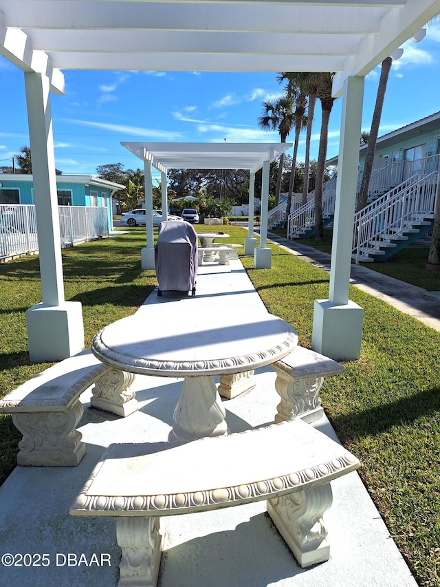 view of community featuring a pergola and a yard