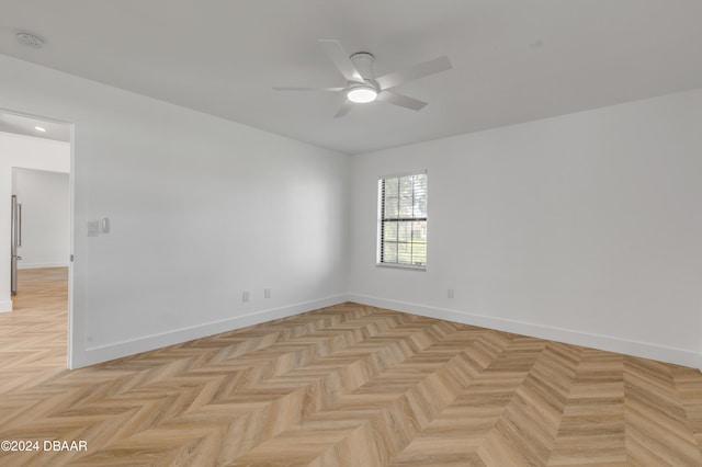 empty room featuring light parquet floors and ceiling fan